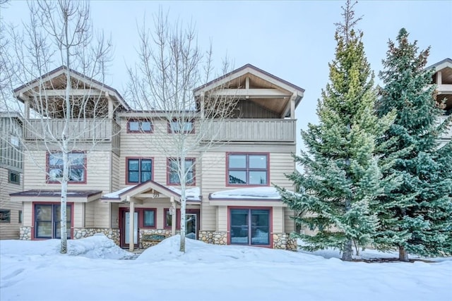 view of front of property with a balcony and stone siding