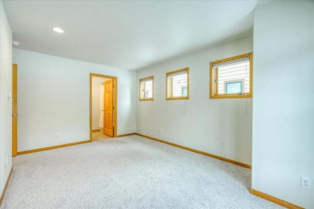 unfurnished room with recessed lighting, light colored carpet, and baseboards