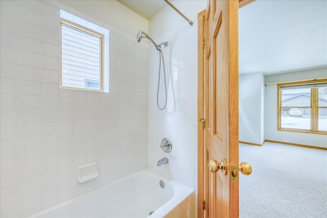 full bathroom with washtub / shower combination and baseboards