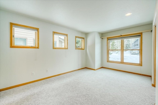 carpeted spare room with recessed lighting and baseboards