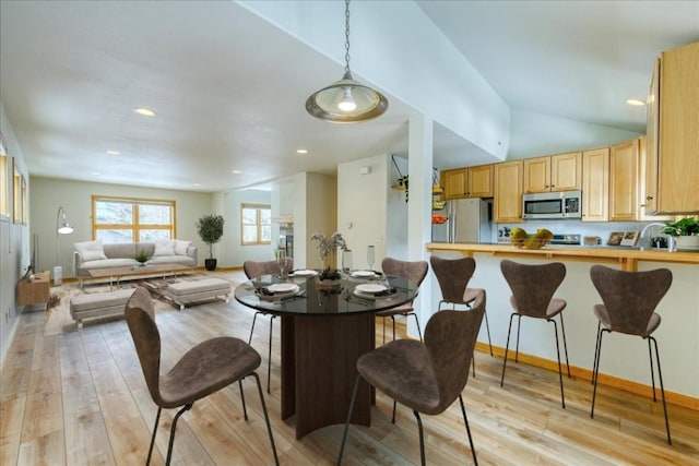 dining area with recessed lighting, baseboards, light wood-style floors, and vaulted ceiling