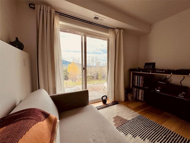 bedroom with hardwood / wood-style flooring and access to outside