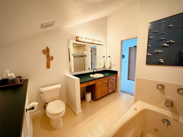 bathroom featuring vaulted ceiling, vanity, a bathtub, and toilet