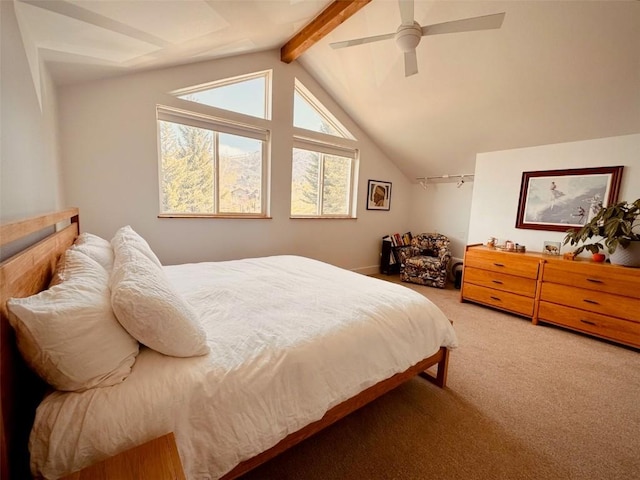 carpeted bedroom featuring lofted ceiling with beams and ceiling fan