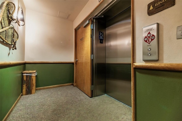 hall with carpet floors and baseboards