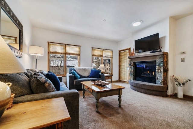 living room with carpet flooring and a fireplace