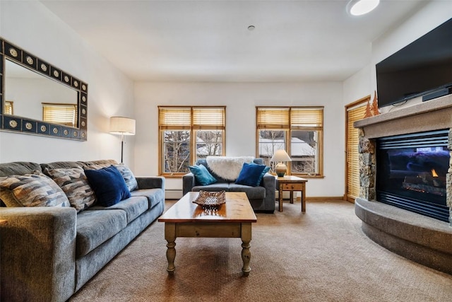 living area with a fireplace, baseboards, baseboard heating, and carpet flooring