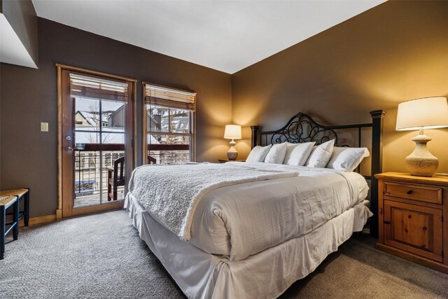 carpeted bedroom featuring access to outside and baseboards