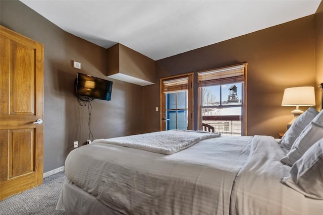 carpeted bedroom featuring baseboards