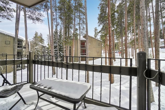 view of snow covered back of property