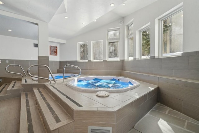 view of pool with an indoor hot tub