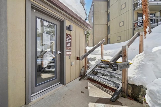 view of snow covered property entrance