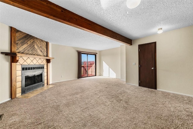 unfurnished living room with a tile fireplace, light carpet, and a textured ceiling