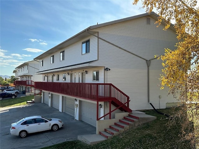 exterior space featuring an attached garage and stairway