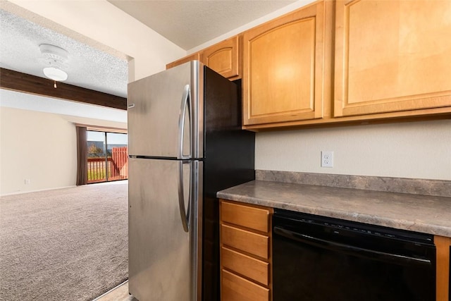 kitchen featuring carpet floors, dark countertops, freestanding refrigerator, a textured ceiling, and dishwasher