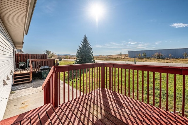 wooden terrace with a lawn