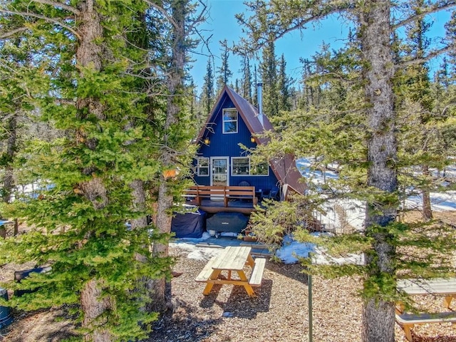 rear view of property with a wooden deck