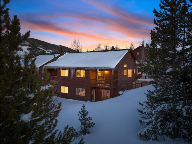 snow covered house with a mountain view