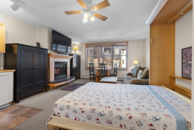 carpeted living room featuring ceiling fan and a baseboard heating unit