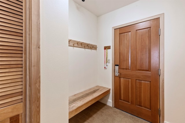 mudroom featuring light colored carpet