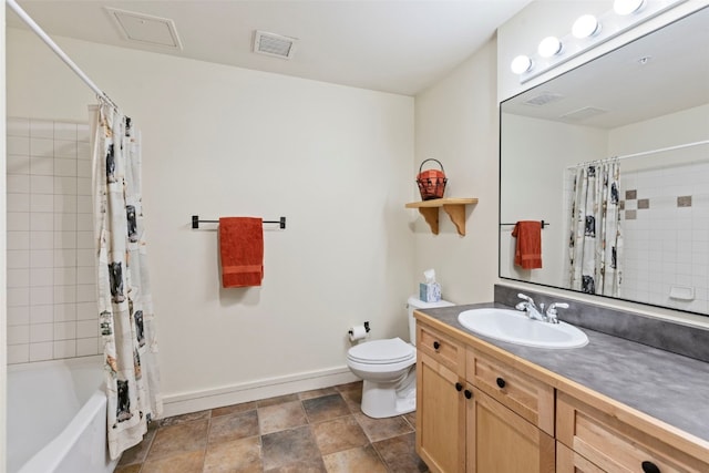 full bath with toilet, vanity, visible vents, baseboards, and shower / bath combo