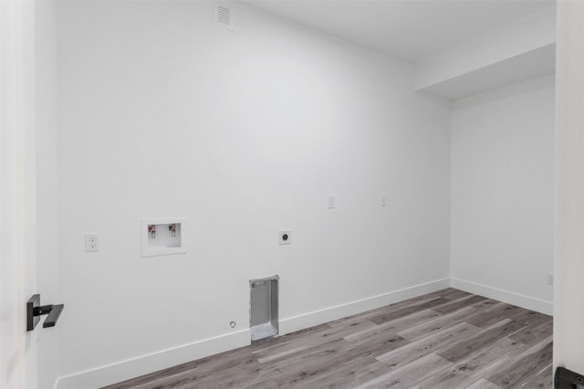 washroom featuring electric dryer hookup, washer hookup, and light wood-type flooring