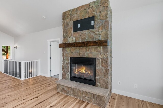 room details featuring a fireplace and hardwood / wood-style flooring