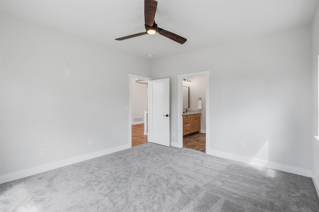 unfurnished bedroom with carpet, ceiling fan, and ensuite bath