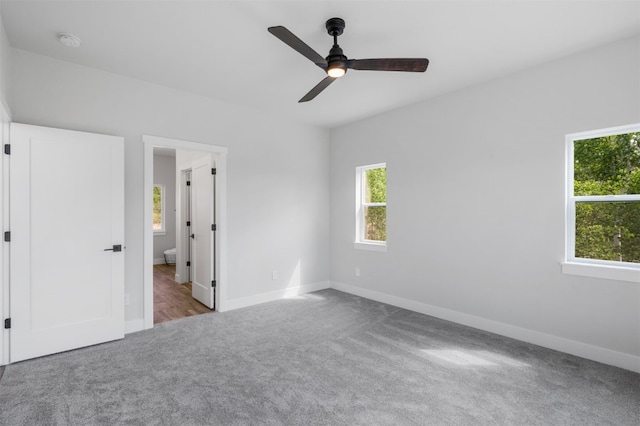 unfurnished bedroom with ceiling fan and light colored carpet