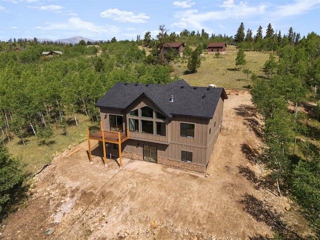 rear view of property with a wooden deck