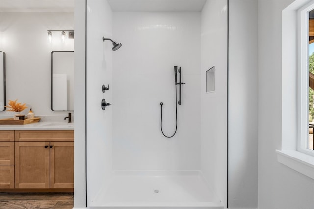 bathroom featuring vanity and a shower