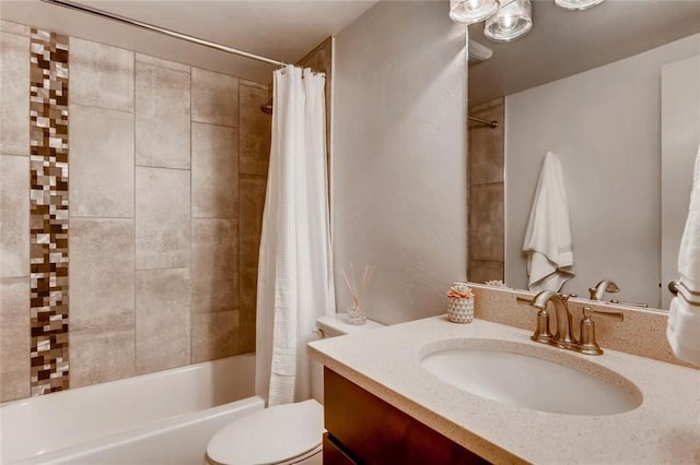 full bathroom featuring vanity, shower / bath combination with curtain, and toilet