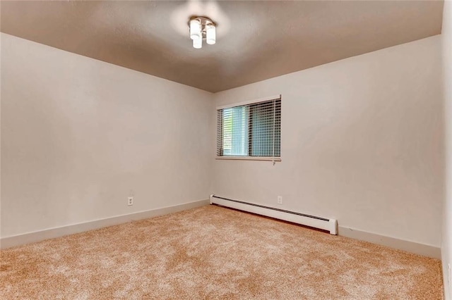 empty room featuring a baseboard radiator and light carpet