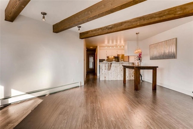 unfurnished living room featuring beamed ceiling, a baseboard heating unit, and dark hardwood / wood-style flooring