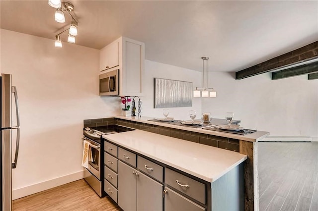 kitchen featuring gray cabinetry, white cabinetry, light wood-type flooring, appliances with stainless steel finishes, and pendant lighting