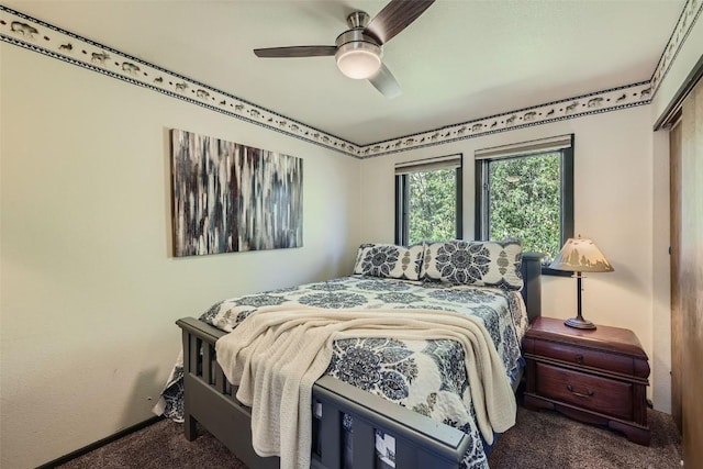 bedroom with a closet, ceiling fan, and carpet