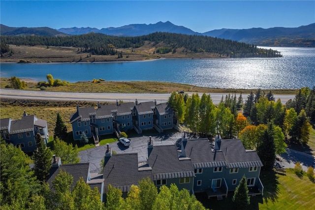 birds eye view of property with a water and mountain view