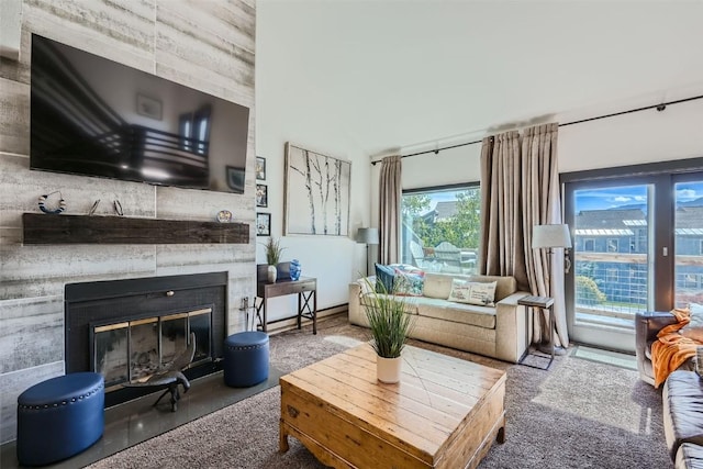 living room with a large fireplace and a wealth of natural light