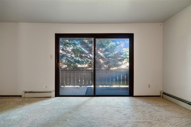 carpeted spare room featuring a baseboard radiator