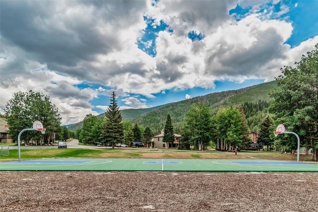 view of property's community featuring a mountain view and basketball hoop