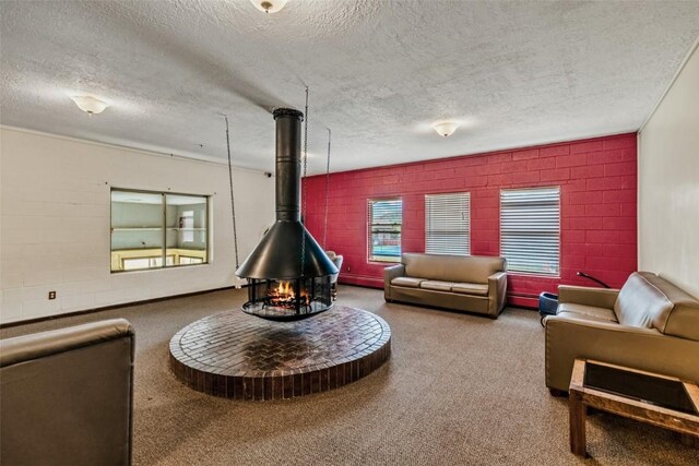 living room with a wood stove and a textured ceiling