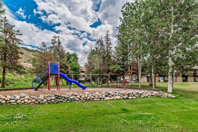 view of jungle gym featuring a lawn