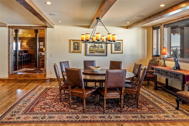 dining room featuring an inviting chandelier, beam ceiling, and hardwood / wood-style floors