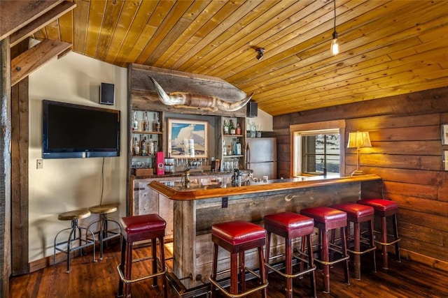 bar with wood-type flooring, stainless steel fridge, wooden ceiling, and vaulted ceiling