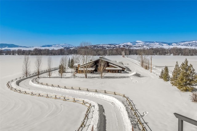 snowy aerial view featuring a mountain view