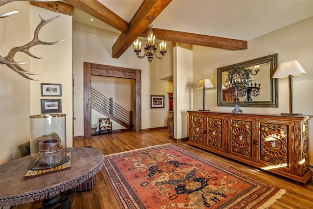 corridor with beam ceiling, a chandelier, and hardwood / wood-style floors