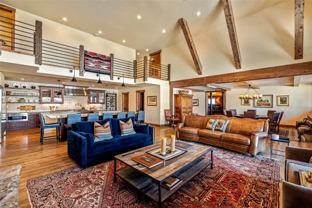 living room featuring hardwood / wood-style flooring, a high ceiling, and beam ceiling