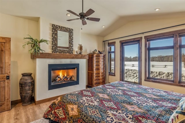 bedroom featuring lofted ceiling, access to outside, ceiling fan, and light hardwood / wood-style flooring