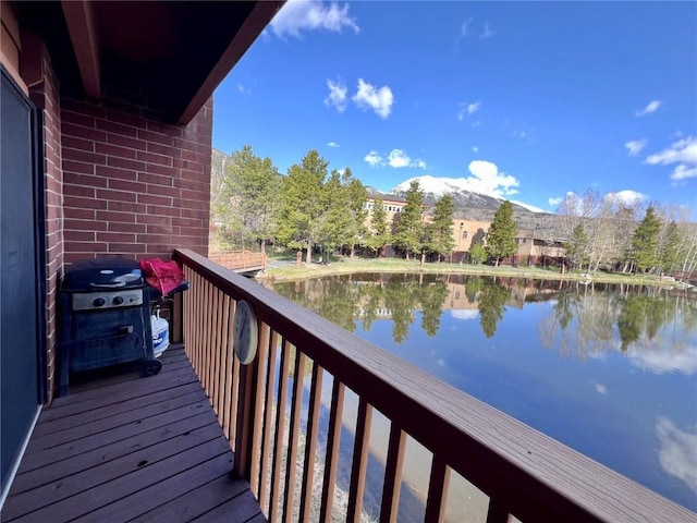 balcony featuring a water view and grilling area