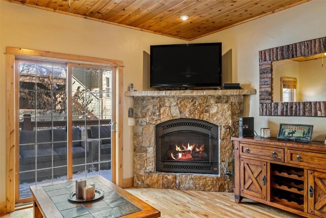 dining area featuring beamed ceiling, light hardwood / wood-style flooring, wooden ceiling, and sink